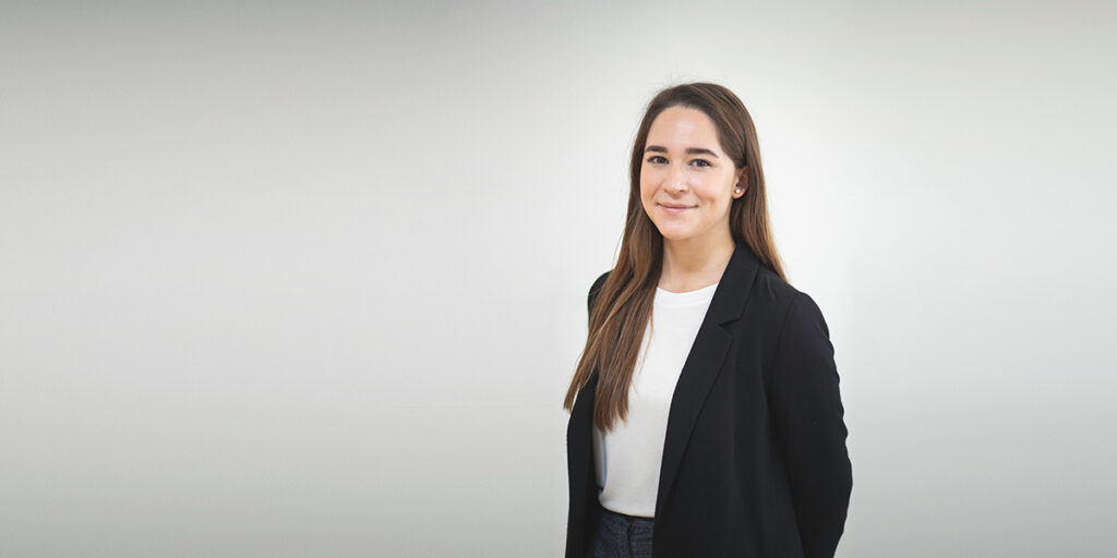 A woman with a white shirt and black business coat